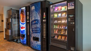 A vending machine with a Pepsi logo, a water dispenser, and a snack vending machine. - Super 8 by Wyndham Sidney NE I-80 (Sidney)