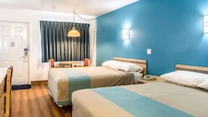 A hotel room with two beds, a desk, a chair, a lamp, and a curtain. - Motel 6 Albany, OR (Albany)