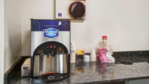 A coffee machine branded 'Maxwell House' with a 'Good to the Last' slogan, a coffee cup, and a 'Your Morning Charge Up for No Charge' sign on a countertop. - Motel 6 Gordonville PA - Lancaster PA (Gordonville)