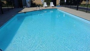 A rectangular swimming pool with a 3 ft depth marker at the shallow end. - Howard Johnson by Wyndham Clarksville Tennessee (Clarksville)