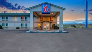 A motel with a prominent '6' sign, a covered entrance, and a parking lot. - Motel 6 Beaver, UT (Beaver)