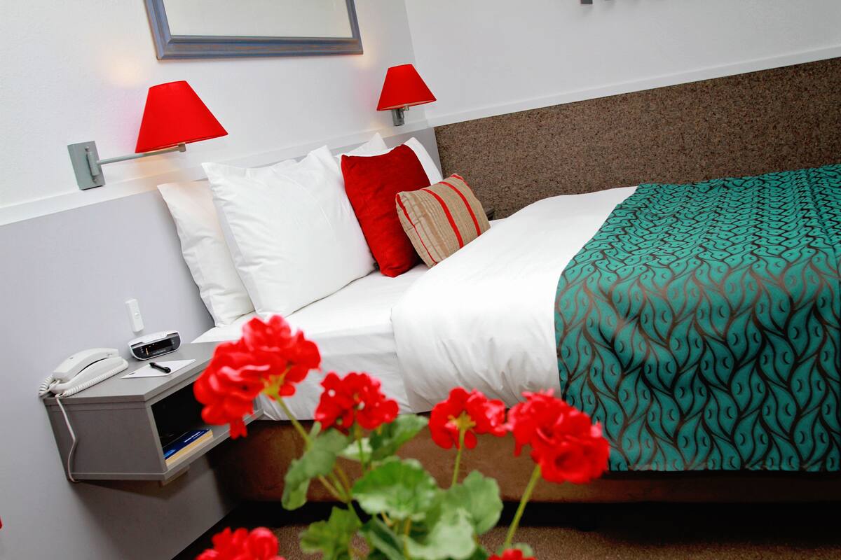 Premium bedding, desk, laptop workspace, iron/ironing board