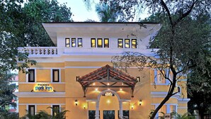 A hotel with a prominent entrance, a covered patio area, and multiple potted plants. - Park Inn by Radisson Goa Candolim (Candolim)
