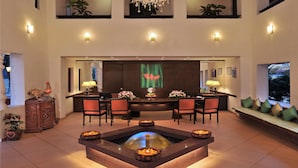 A spacious lobby with a central fire pit, seating area, and a chandelier. - Park Inn by Radisson Goa Candolim (Candolim)