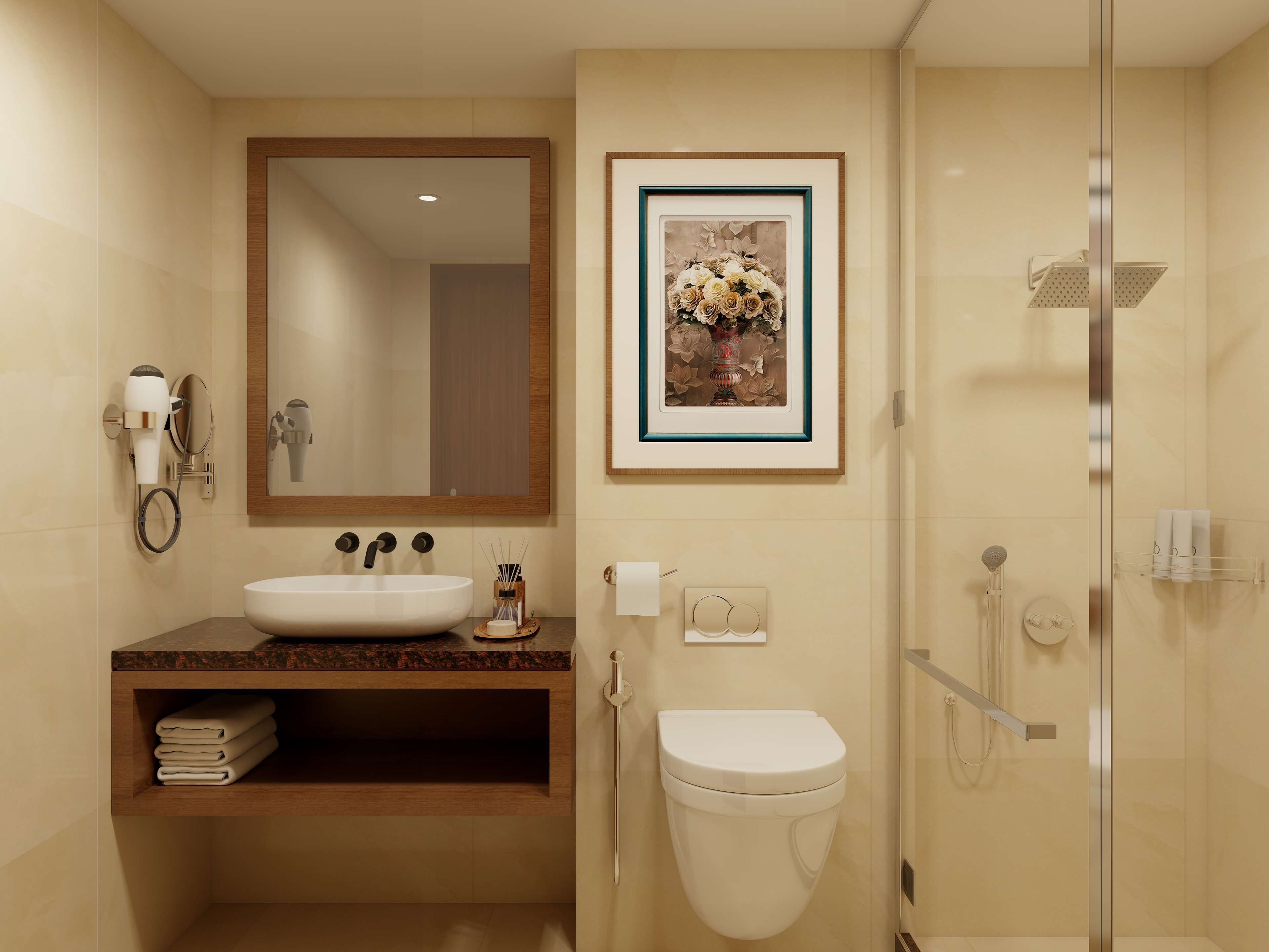 Une salle de bain moderne équipée d’un lavabo, d’un miroir, de toilettes et d’une douche.