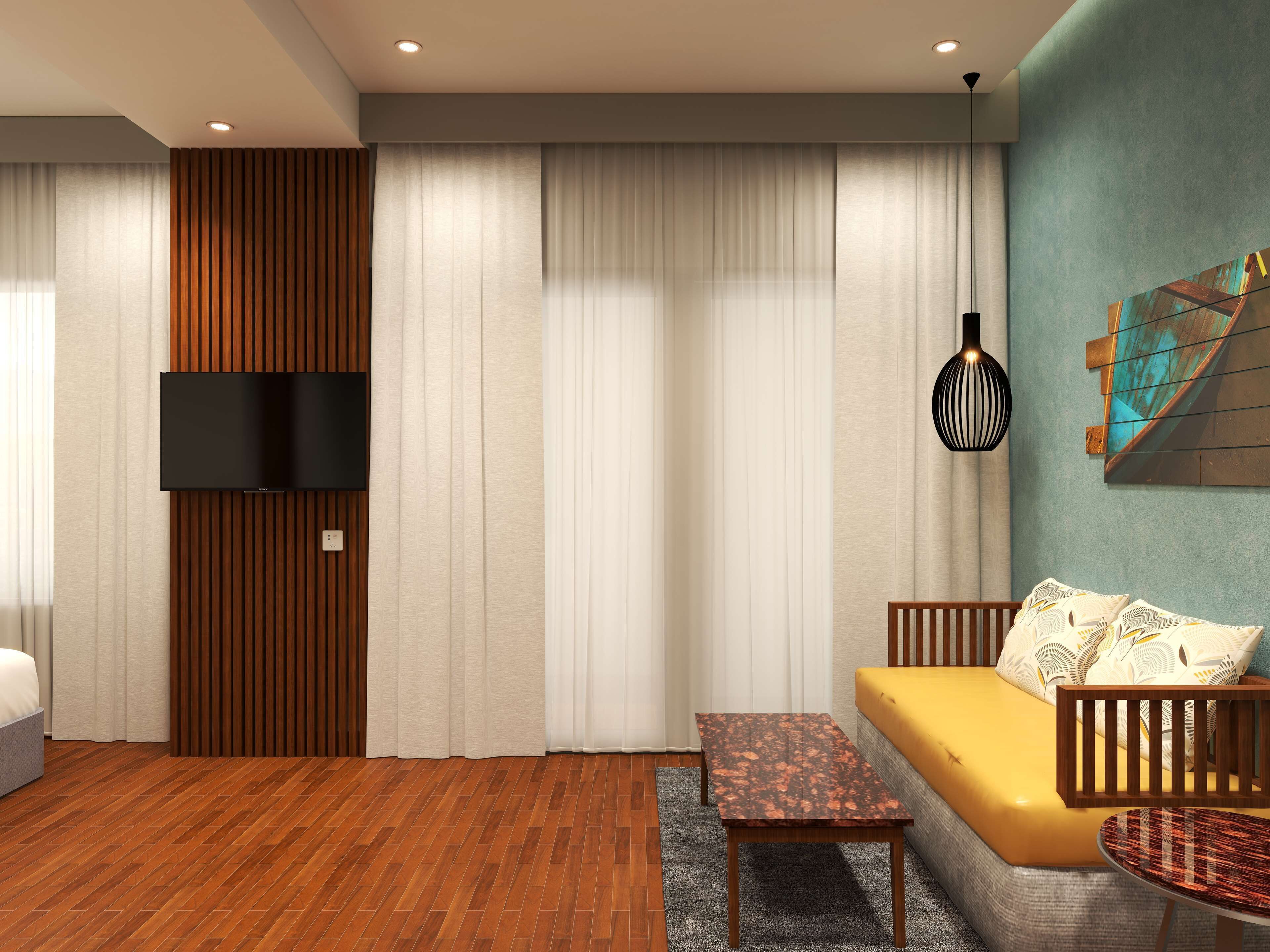 A modern living room with a wooden floor, a yellow sofa, a small table, and a TV mounted on the wall.
