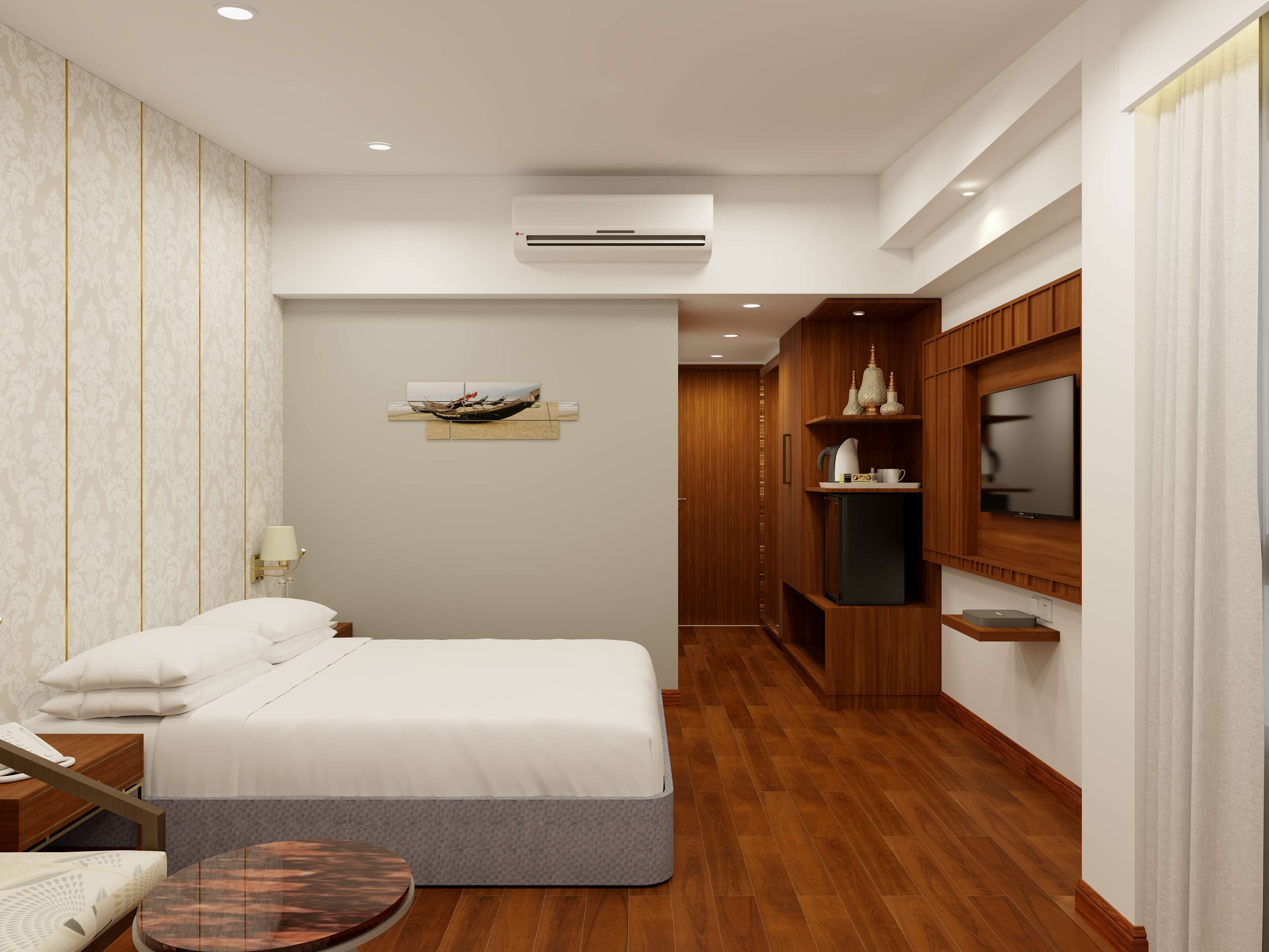 A modern hotel room with a bed, a small round table, a TV, and a wooden cabinet.