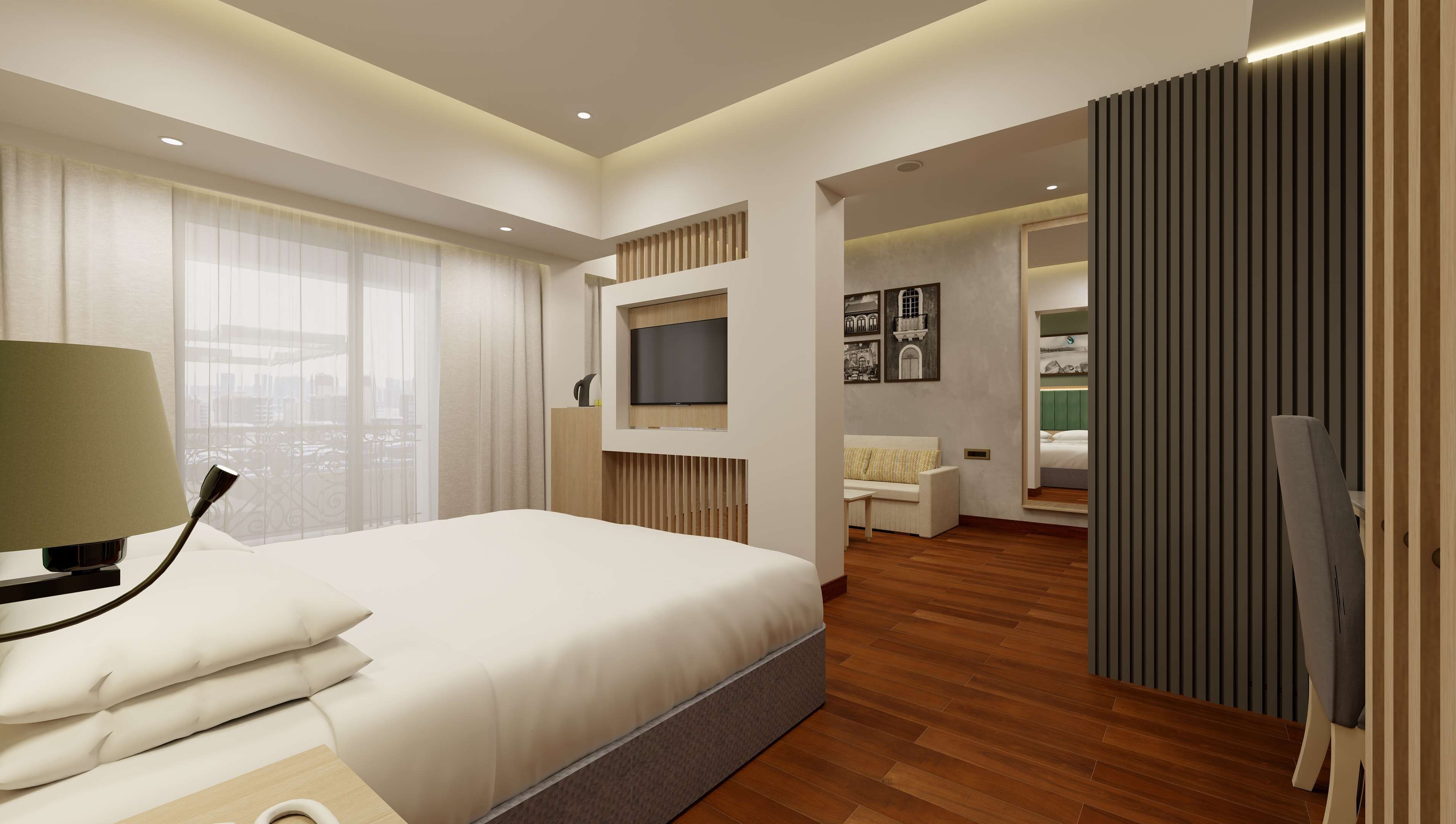 A modern hotel room with a large bed, a TV mounted on the wall, and a view of the city through large windows.