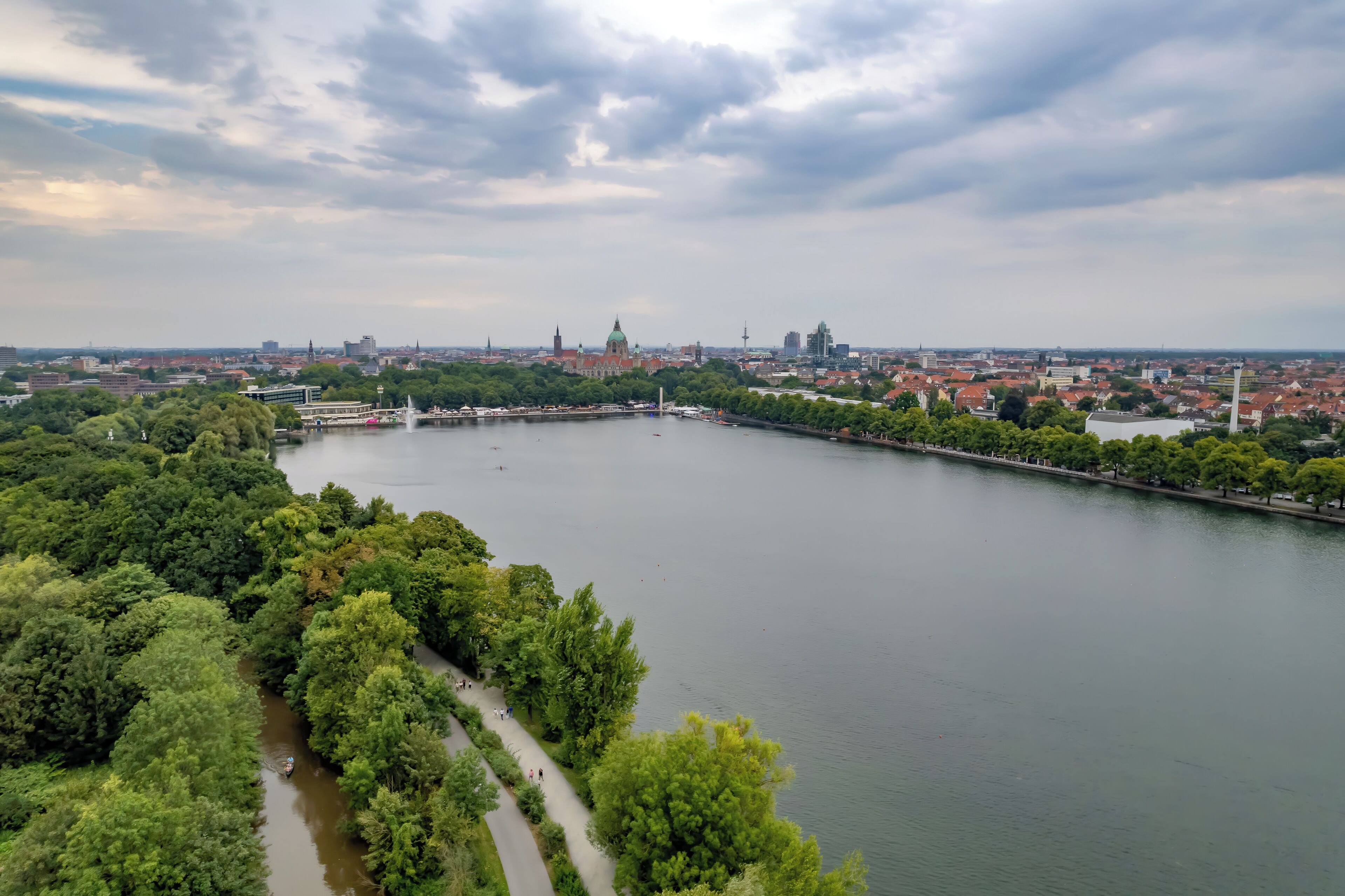 A river with a bridge and a park with trees.