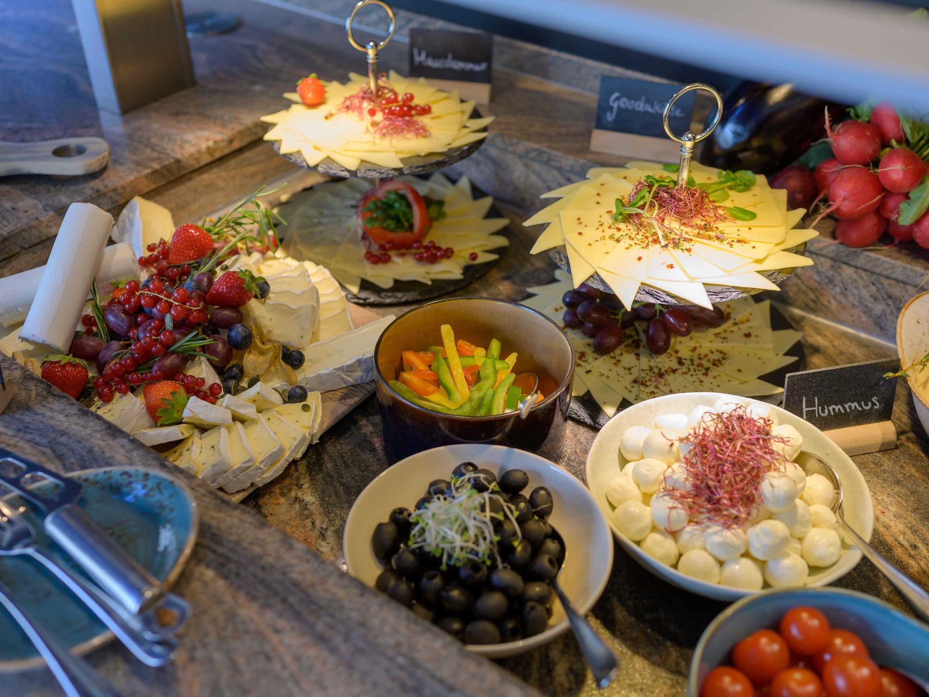 A variety of cheeses and accompaniments on a buffet table.