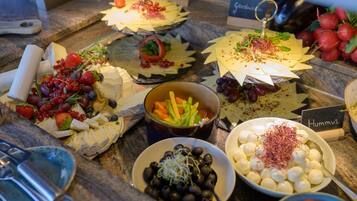 A variety of cheeses and accompaniments on a buffet table.