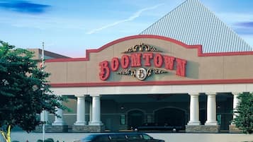 A building with a large sign reading "BOONTOWN" and a black car parked in front.