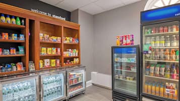 A beverage and snack section with refrigerated cases and shelves stocked with various products.