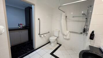 A modern bathroom with a toilet, bidet, and shower.