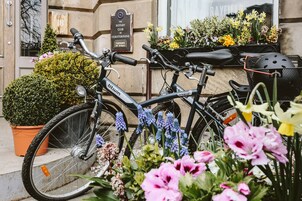 A bicycle parked in front of a building with a sign indicating a club.