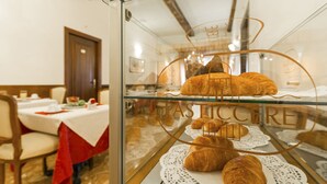 A glass display case with pastries and a sign reading "Pasticcere." - Palazzo Guardi (Venice)