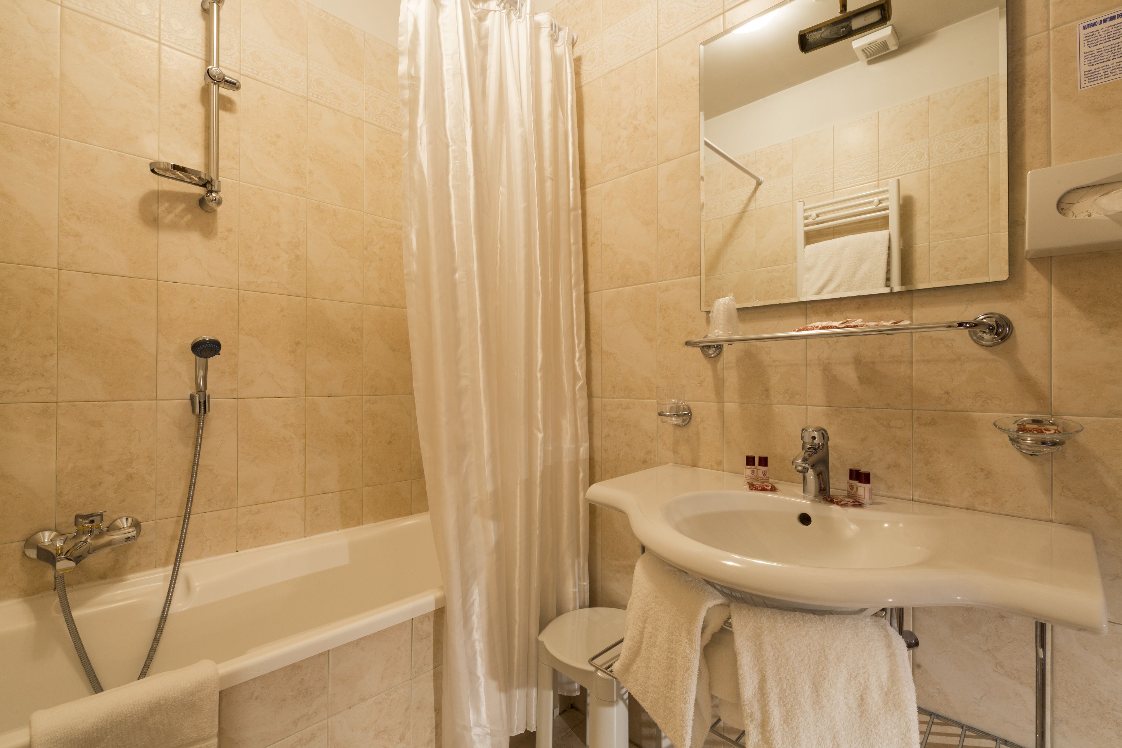 A bathroom with a bathtub, shower, and sink.