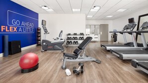 A modern gym with treadmills, a bench press, dumbbells, and a red exercise ball. - Holiday Inn Express Las Vegas - Stadium Area by IHG (Las Vegas)
