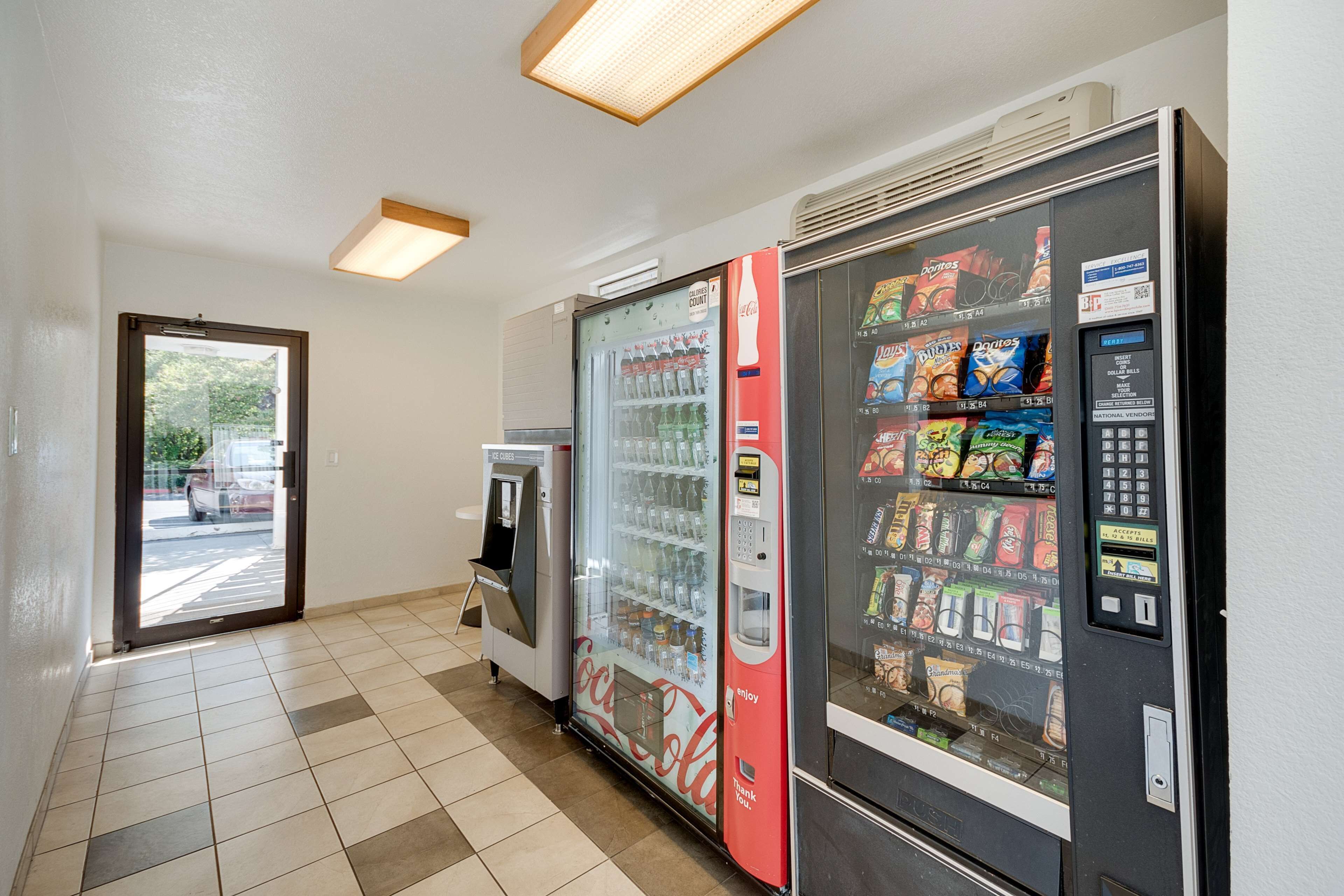 A vending area with a Coca-Cola machine and a snack vending machine.
