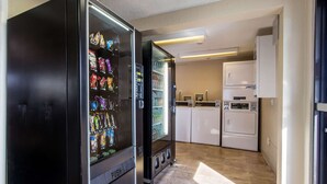 A hotel room with a minibar, a refrigerator, a washing machine, and a microwave. - Rodeway Inn Near Hall of Fame (North Canton)