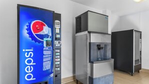 A vending machine with a Pepsi logo, a water dispenser, and a refrigerator. - Red Roof Inn Houston – Jersey Village (Houston)