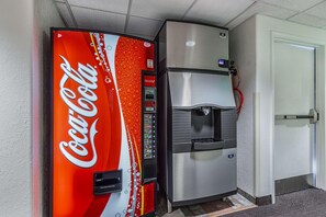 A Coca-Cola vending machine and a stainless steel refrigerator in a hallway. - Motel 6 Beatty, NV - Death Valley (Beatty)
