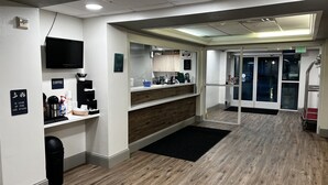 A clean, modern lobby with a coffee station, a flat-screen TV, and a reception desk. - Quality Inn Yuba City/Marysville (Yuba City)