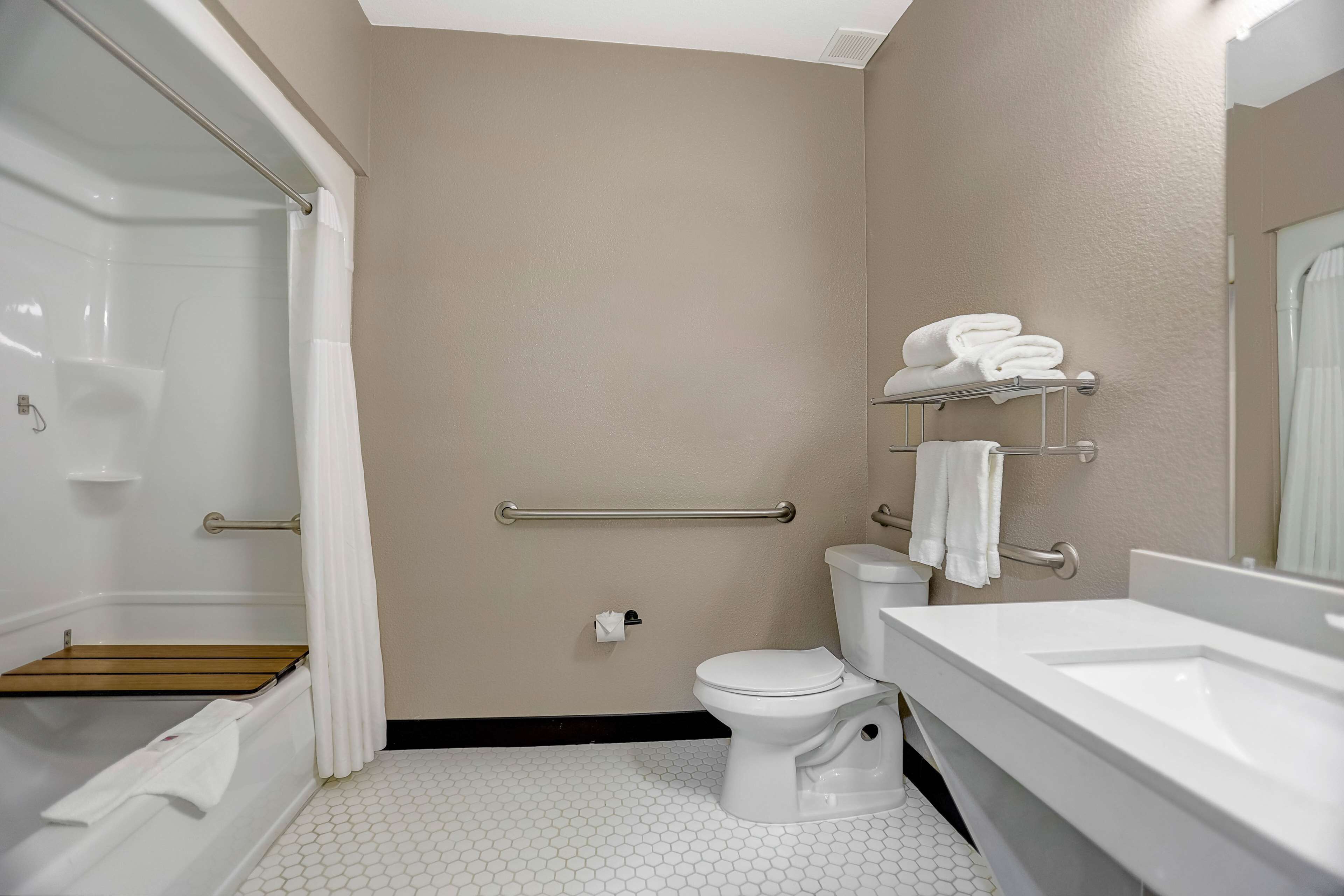 A bathroom with a bathtub, toilet, and sink.