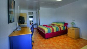 A bedroom with a bed, desk, chair, and a small cabinet. - Best Western Halls Creek Motel (Halls Creek)