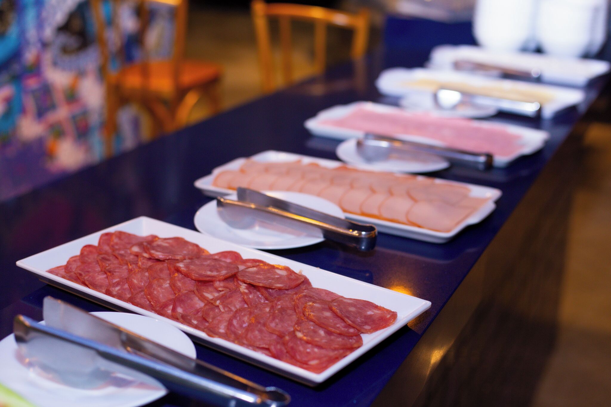 A buffet table with various food items.