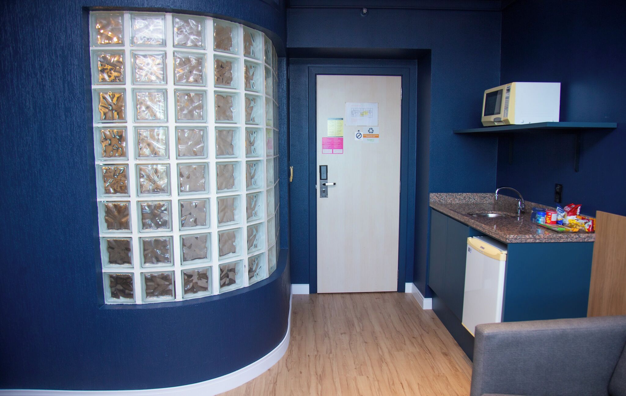 A compact kitchen with a microwave, a sink, and a refrigerator.