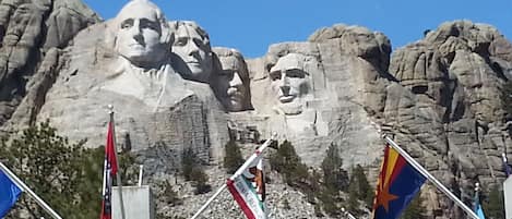 A large mountain with a prominent statue in the background.
