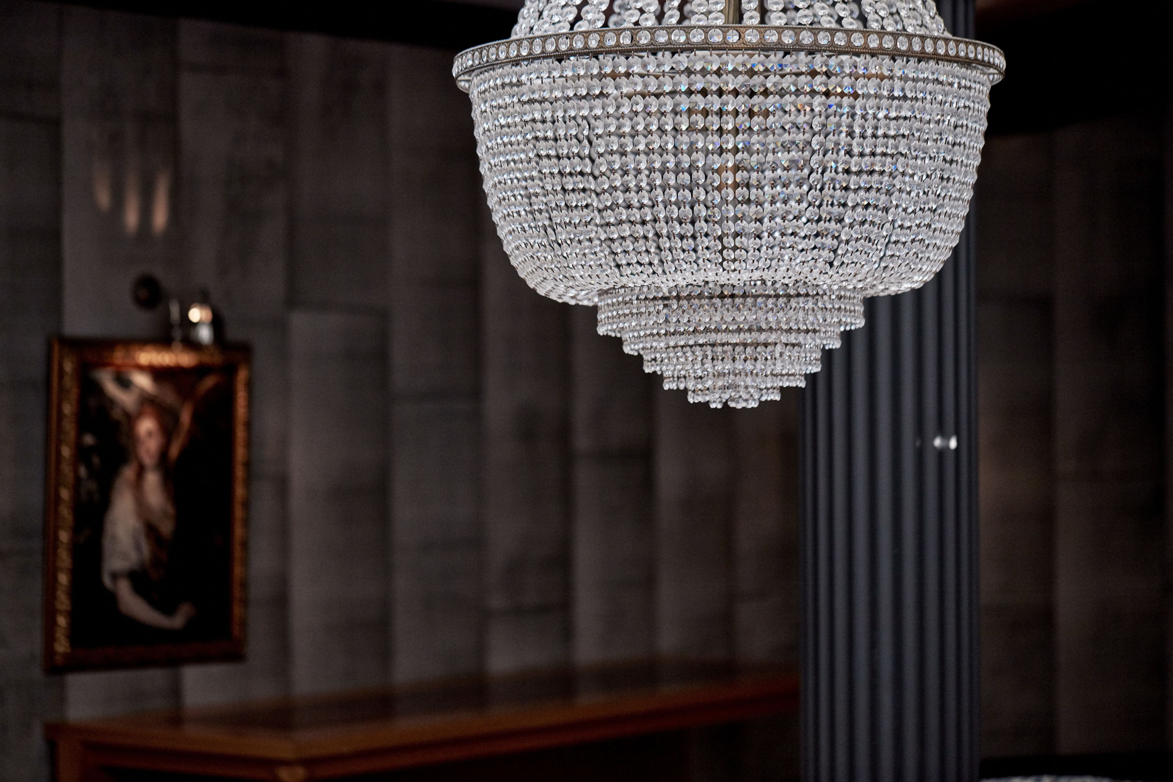 A chandelier with multiple tiers of crystals hanging from the ceiling.