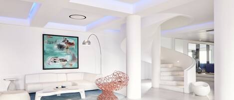 Ein modernes Interieur mit einem weißen Sofa, einem roten Designstuhl und einem Gemälde an der Wand.
