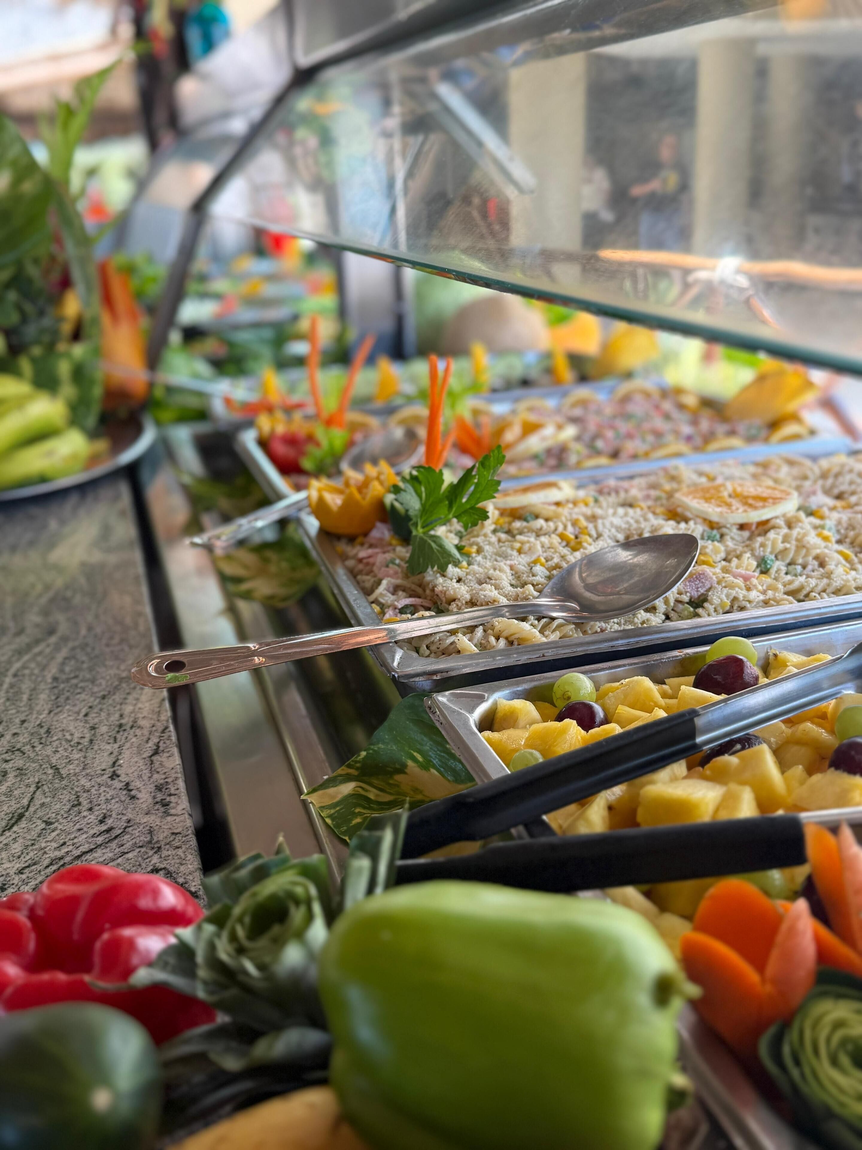 A buffet with various food items and utensils.