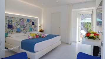A modern bedroom with a bed, a desk, and a chair.