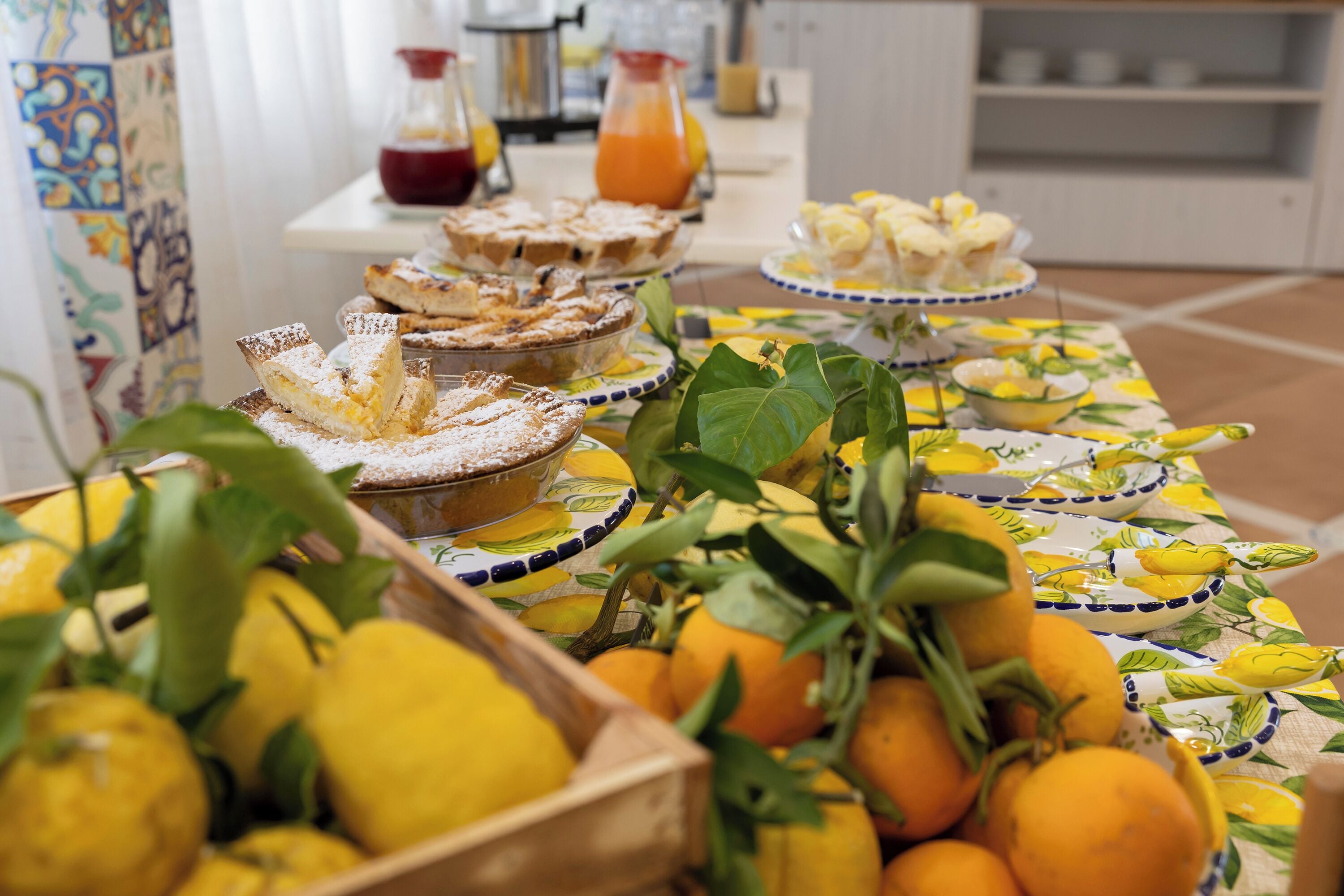 A breakfast buffet with various dishes and fresh lemons.
