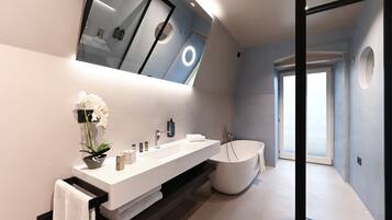 Un bagno moderno con uno specchio grande, un lavabo bianco, una vasca e un'orchidea in vaso.