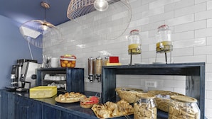 A buffet counter with various food items and condiments.