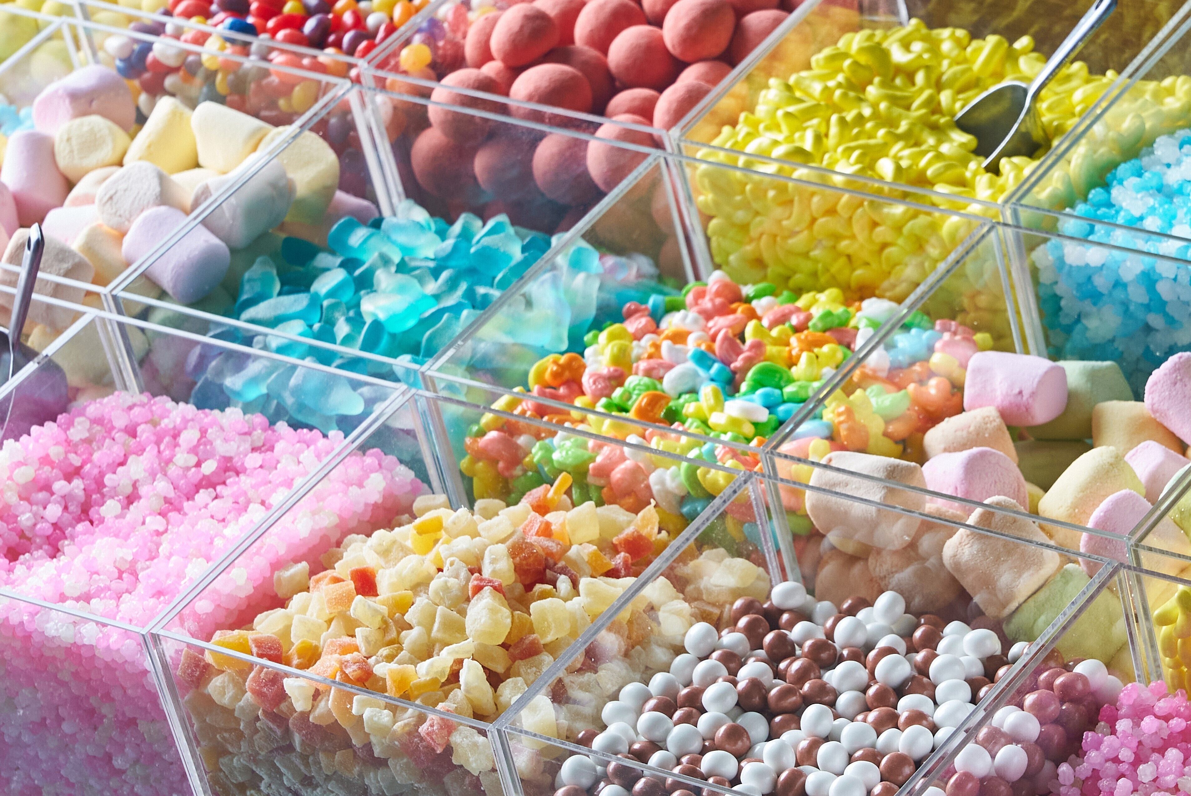 A candy display case with various types of candies organized in compartments.