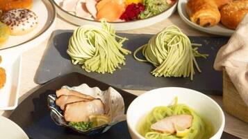 A variety of dishes including pasta, a bowl of soup, and a plate with meat and vegetables.