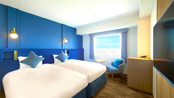 A hotel room with two beds, a desk, a chair, and a large window with a city view.