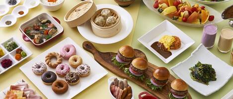 A variety of breakfast foods including pastries, meats, and beverages.