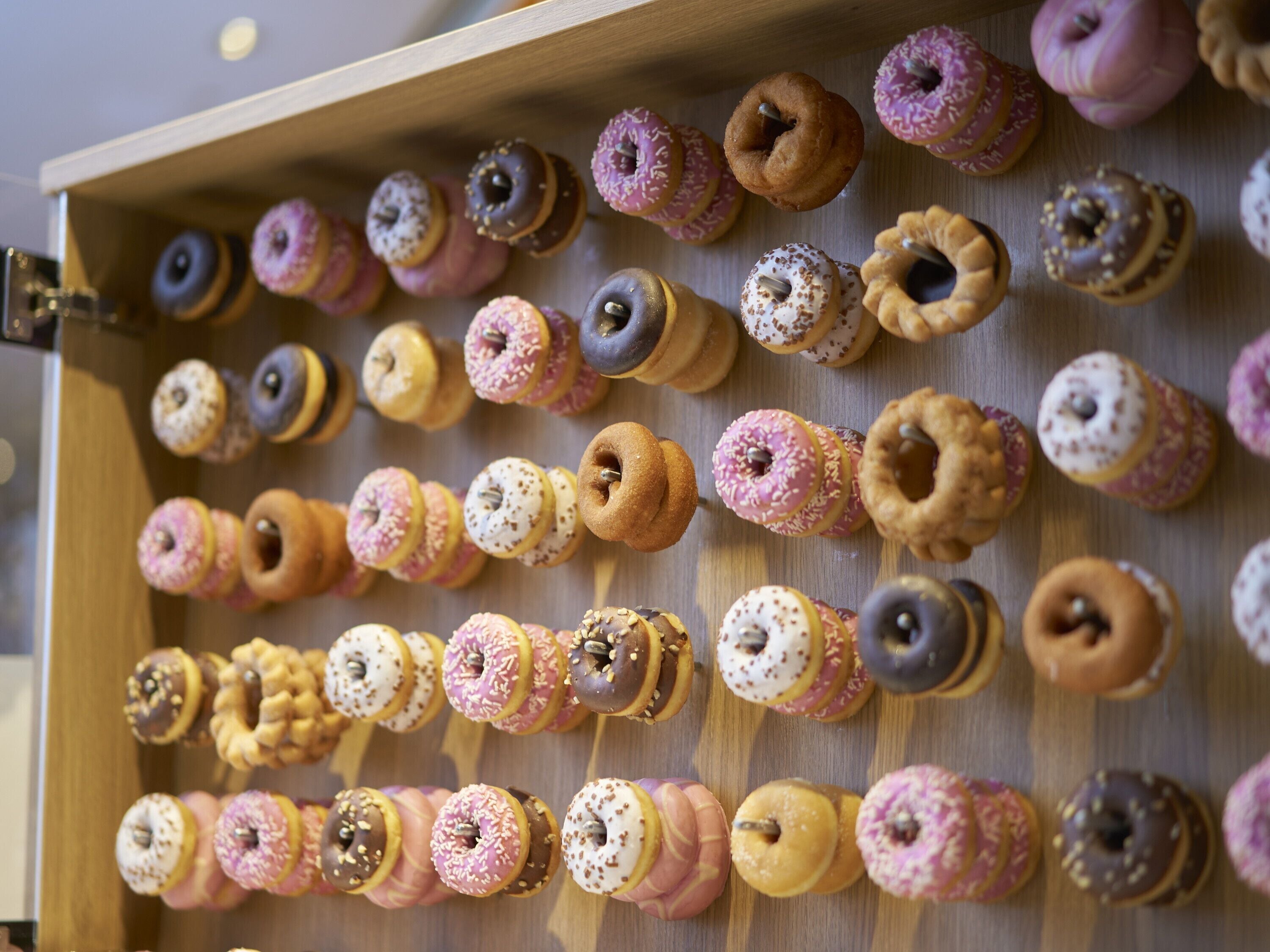 A display case filled with various donuts.