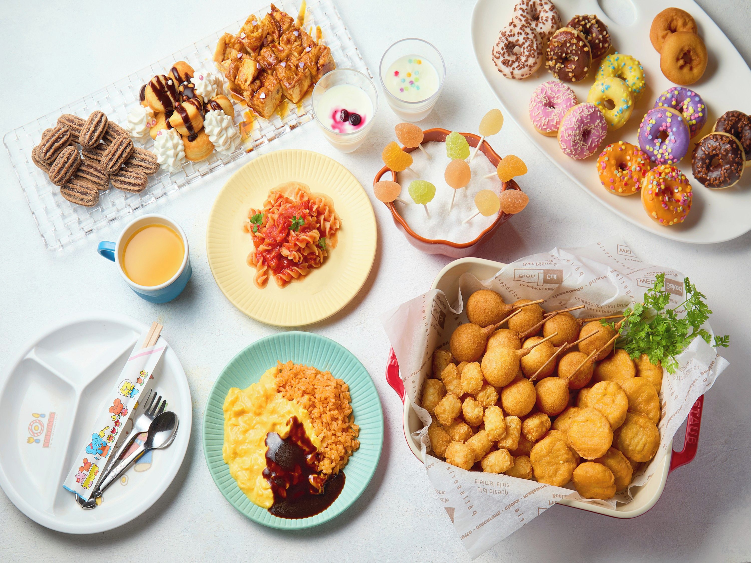A variety of food items including pasta, fried dough, and donuts.