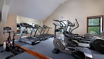 A home gym with treadmills, elliptical machines, and a stationary bike.