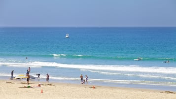 On the beach, surfing