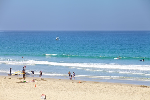 On the beach, surfing