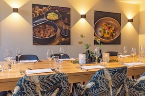 A dining table set for six with chairs, wine glasses, and a candle centerpiece. - Fletcher Hotel - Restaurant Doorwerth - Arnhem (Doorwerth)
