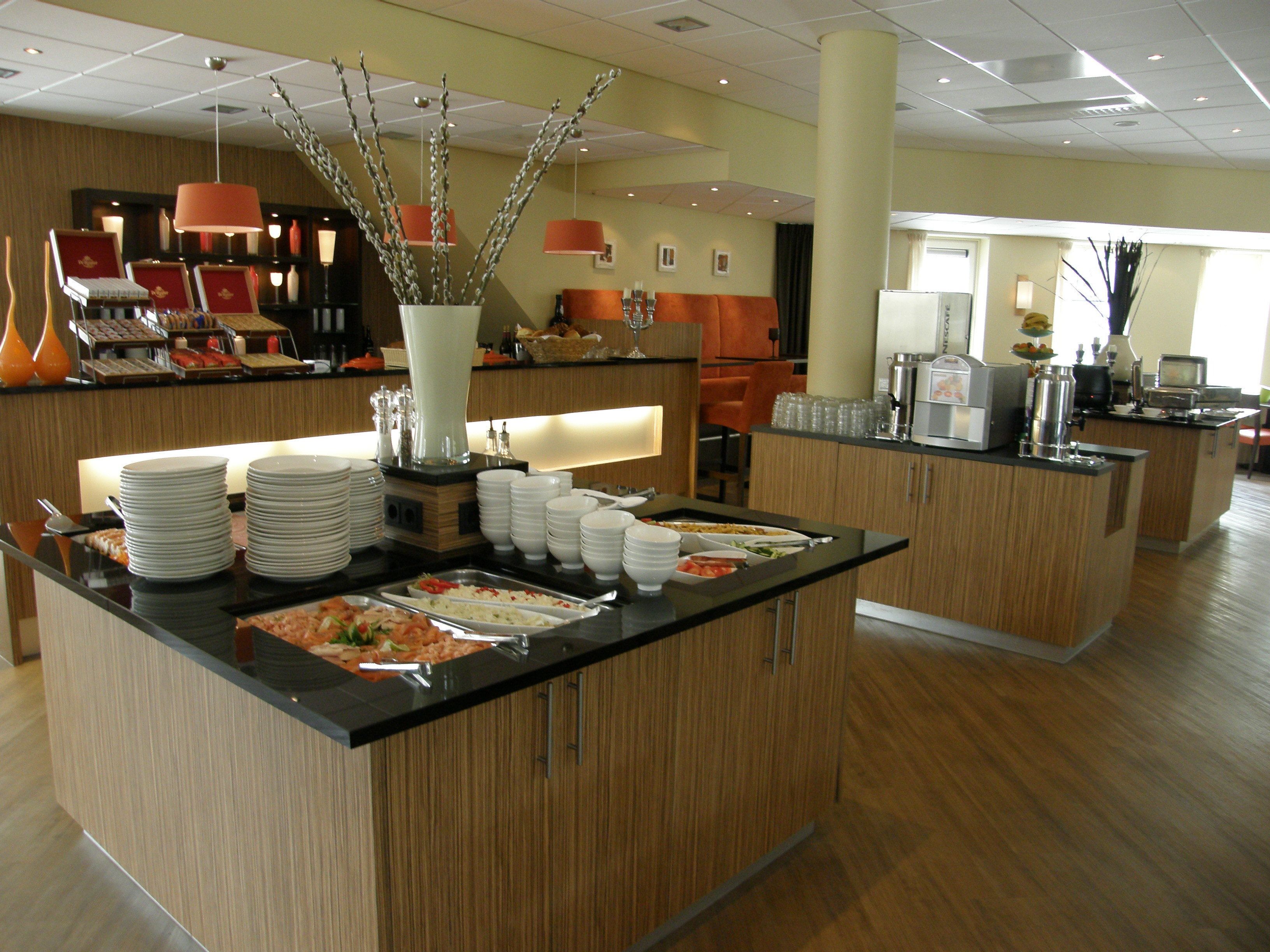 A buffet area with multiple serving stations, a variety of dishes, and a modern interior design.